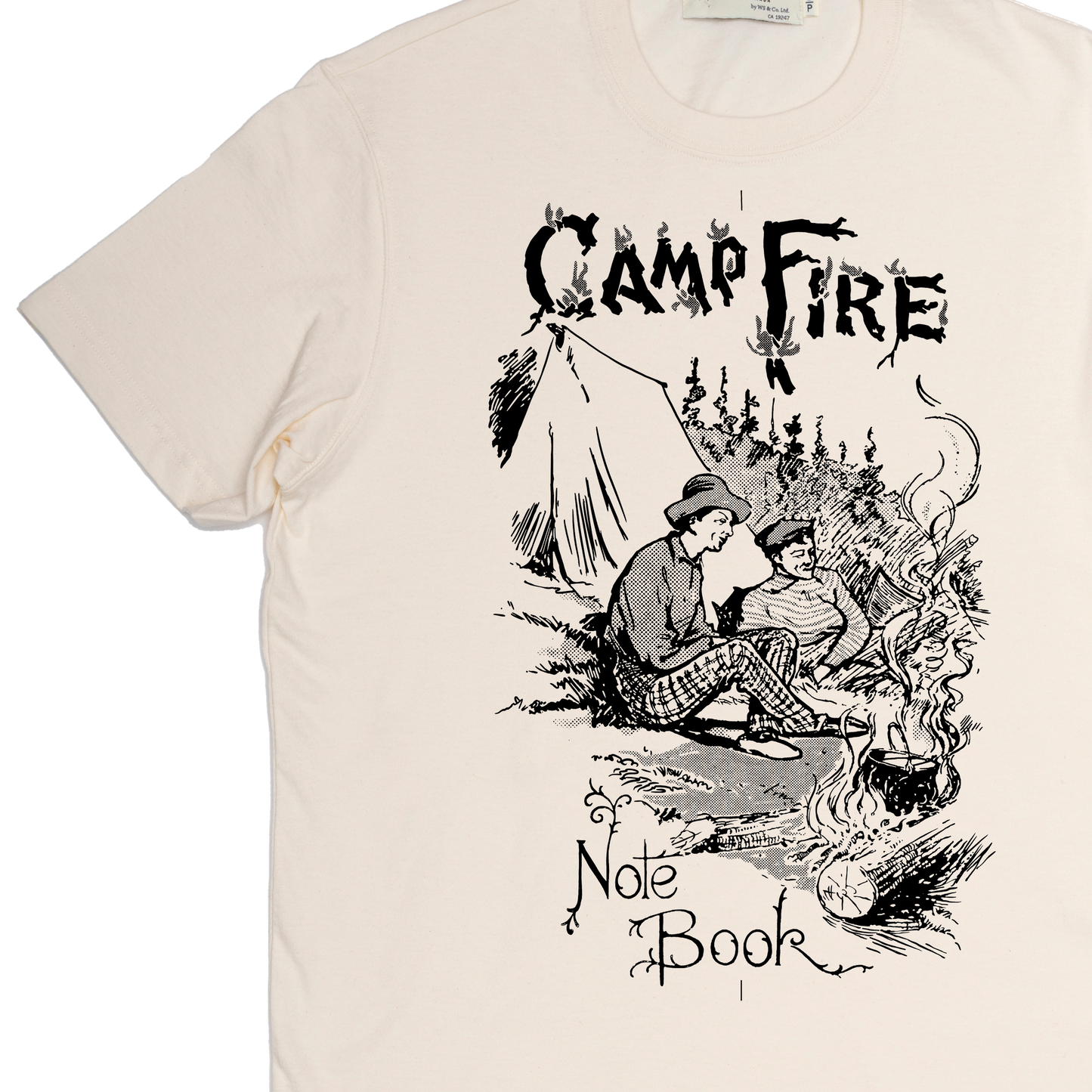Beige t-shirt with black graphic design of two people by a campfire and text 'Camp Fire Note Book'.