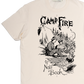 Beige t-shirt with black graphic design of two people by a campfire and text 'Camp Fire Note Book'.