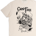 Beige t-shirt with black graphic design of two people by a campfire and text 'Camp Fire Note Book'.